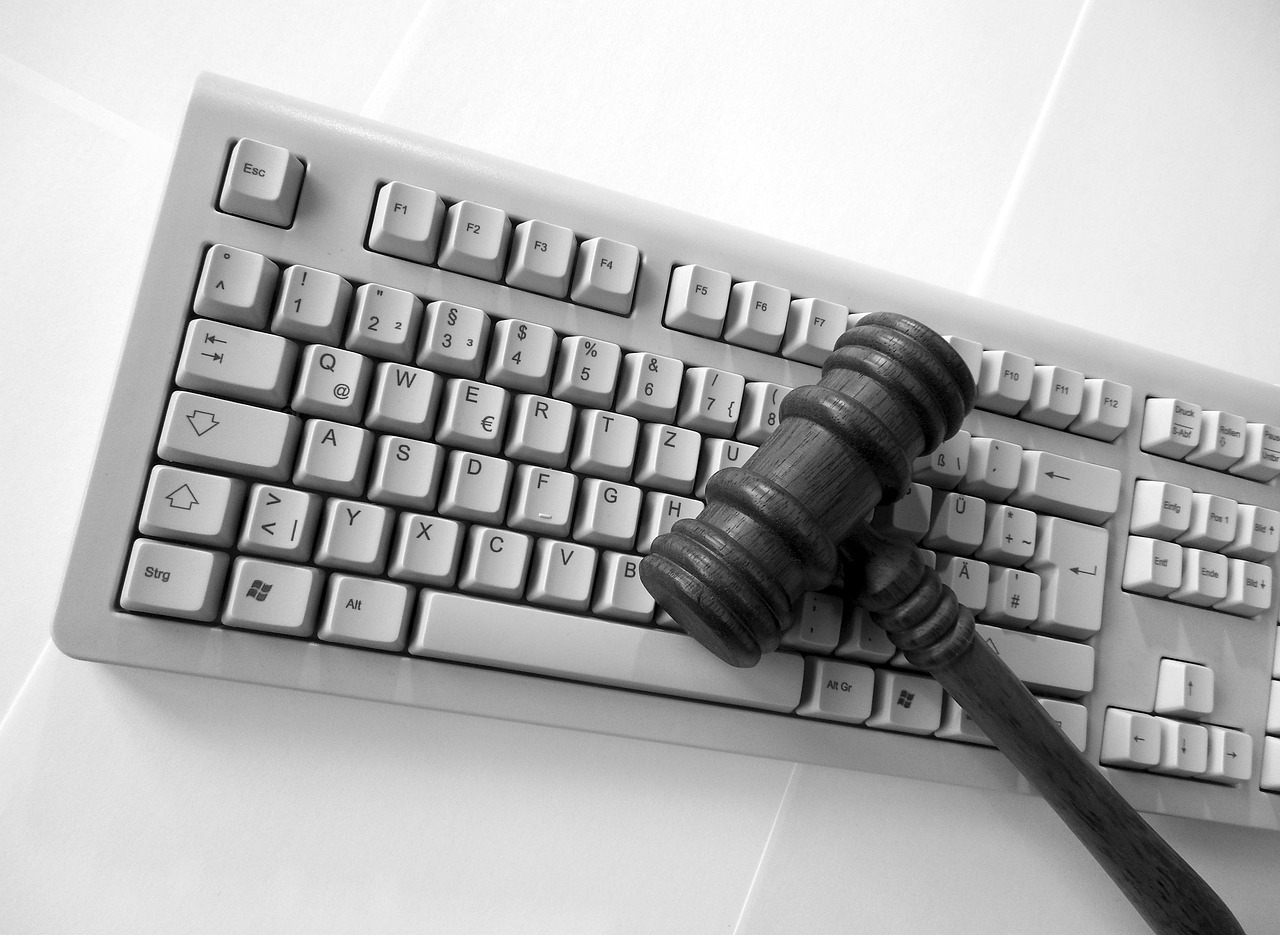 A gavel resting on a computer keyboard.